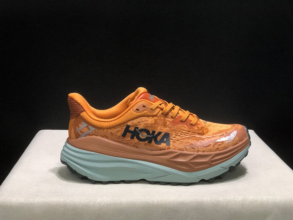 Orange HOKA Stinson 7 Trail Running Shoes - product image from the listing.
