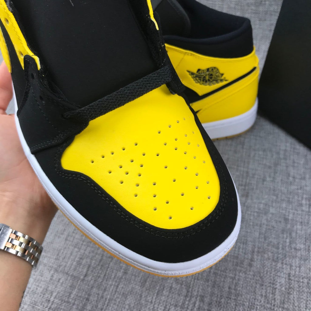 Air Jordan 1 Mid Sneakers in Black and Yellow - product image from the listing.
