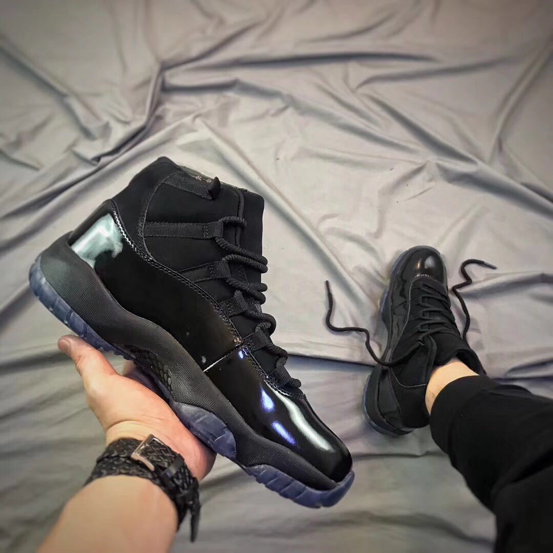 Air Jordan 11 Cap and Gown High-Top Sneakers in Black - product image from the listing.