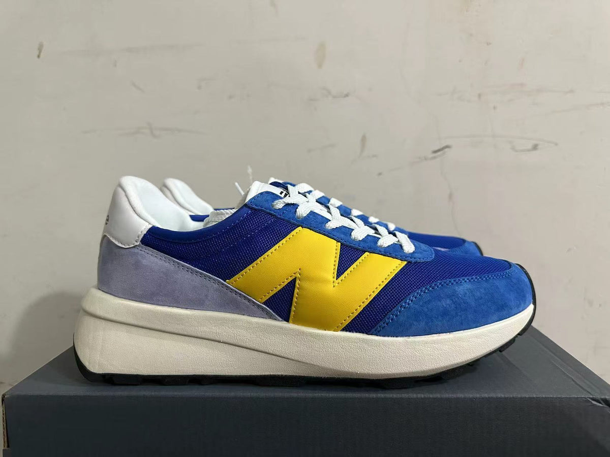 New Balance U370 Sneakers in Blue and Yellow - product image from the listing.